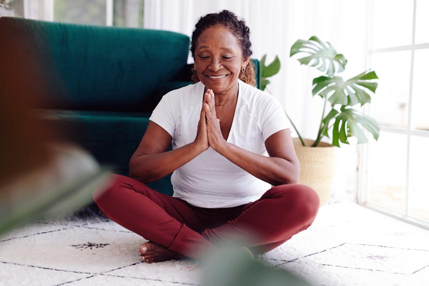 A woman meditating on the floor