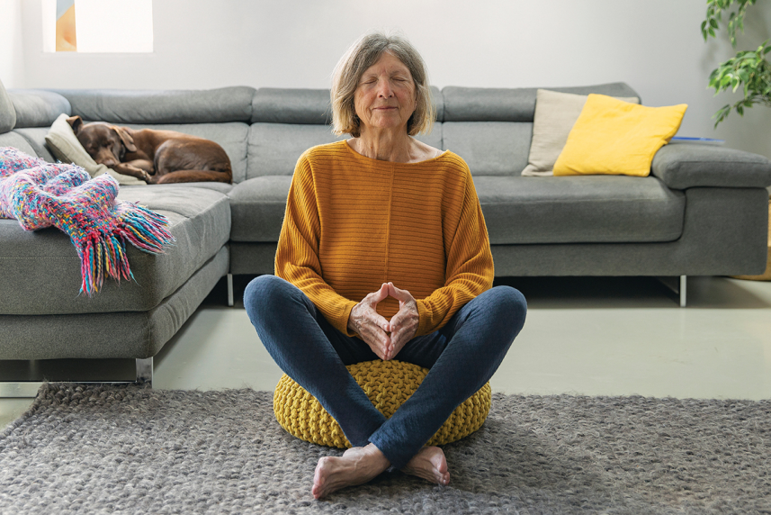 A woman sitting, taking a deep breath