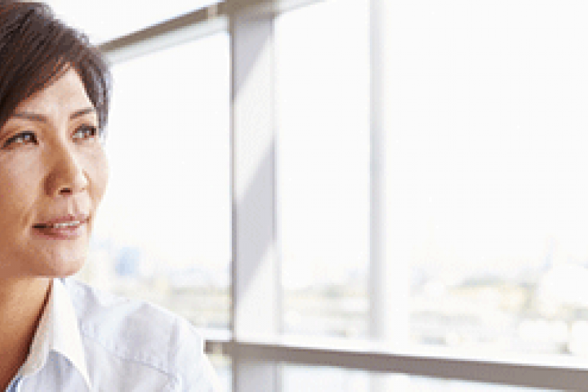 Photo: Business woman staring out a window